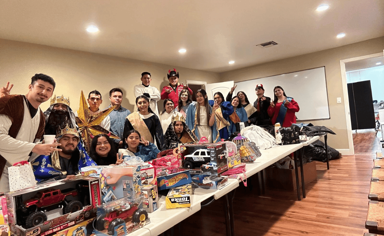 Volunteers beside toys collected for a drive