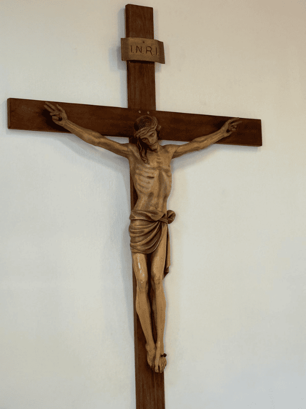Wooden crucifix on a white wall