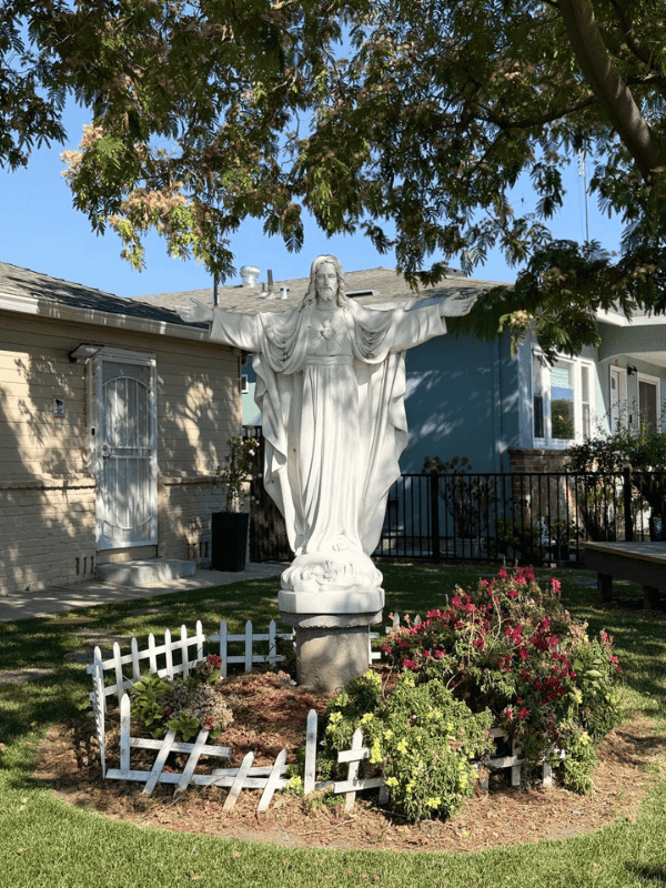 White statue of Christ in the parish garden
